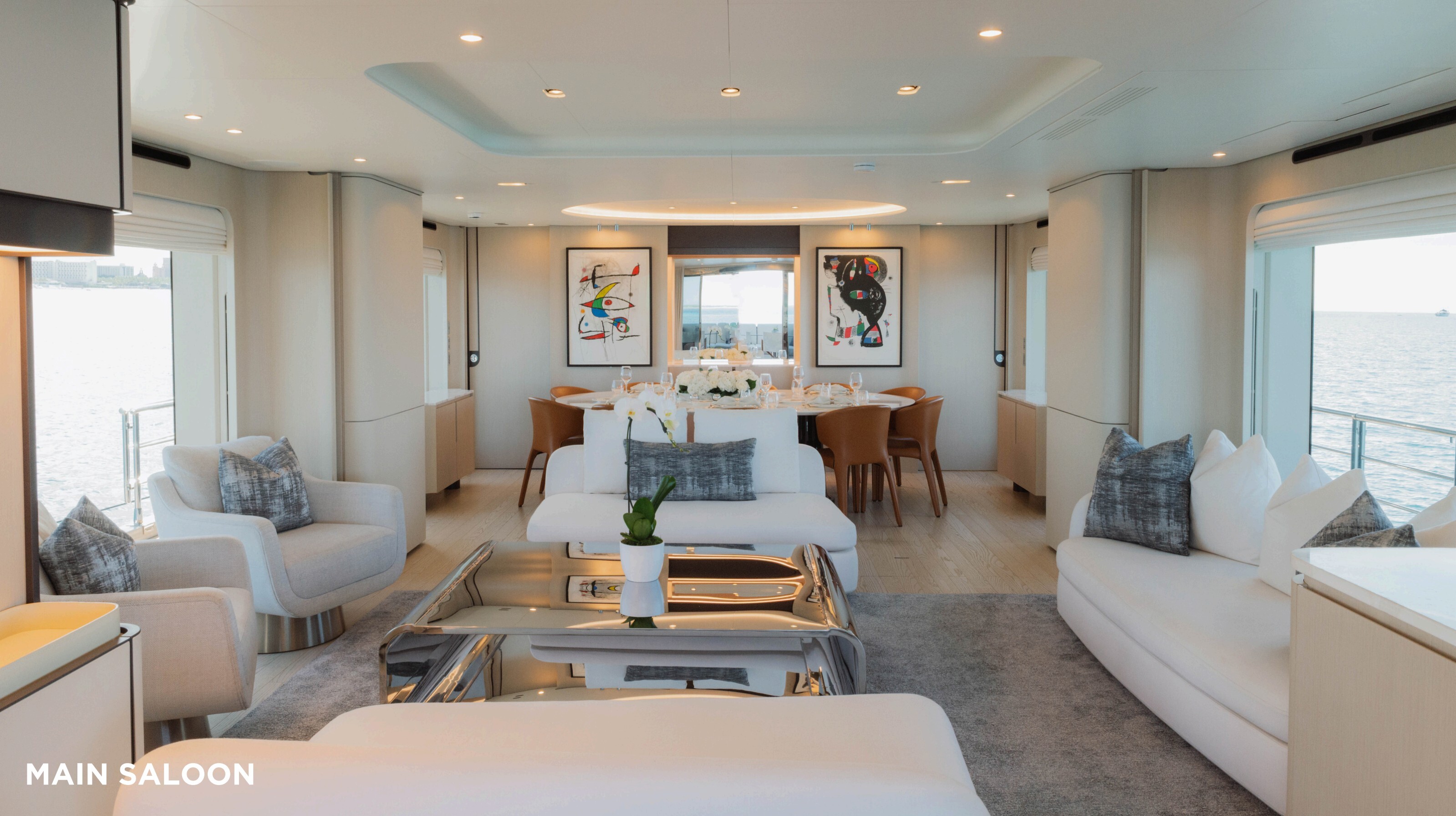 Main saloon with white sofas and large windows